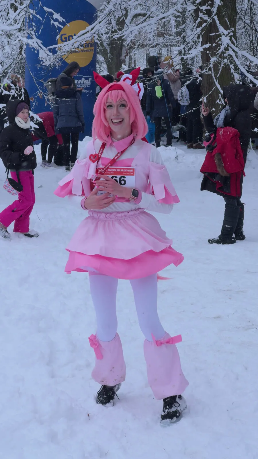 Toraishya in a pink and white Haru Urara outfit with horse ears, smiling in the snow before a race
